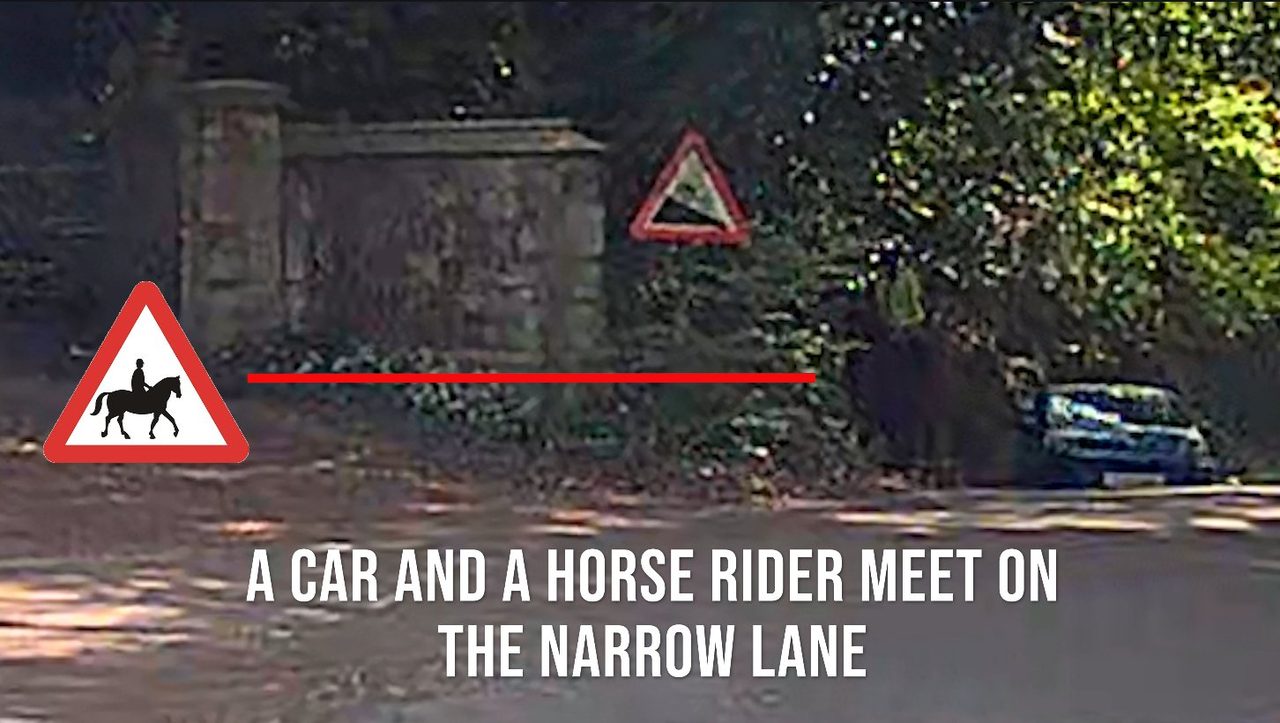 A car and a horse rider meeting on the narrow lane beside the stone gateposts at the proposed entrance, with an official horse-rider warning sign shown alongside.