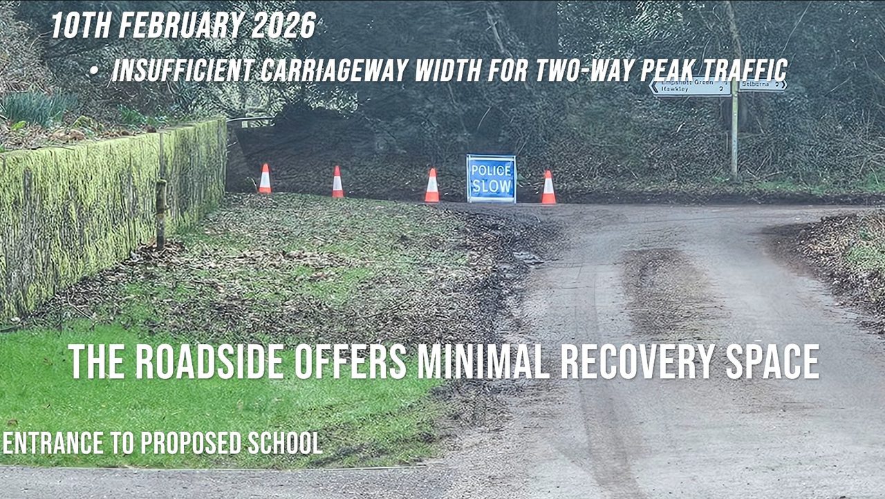 The junction at the proposed school entrance, 10 February 2026: a police 'SLOW' board and traffic cones in the lane, with a fingerpost to Empshott Green, Hawkley and Selborne.