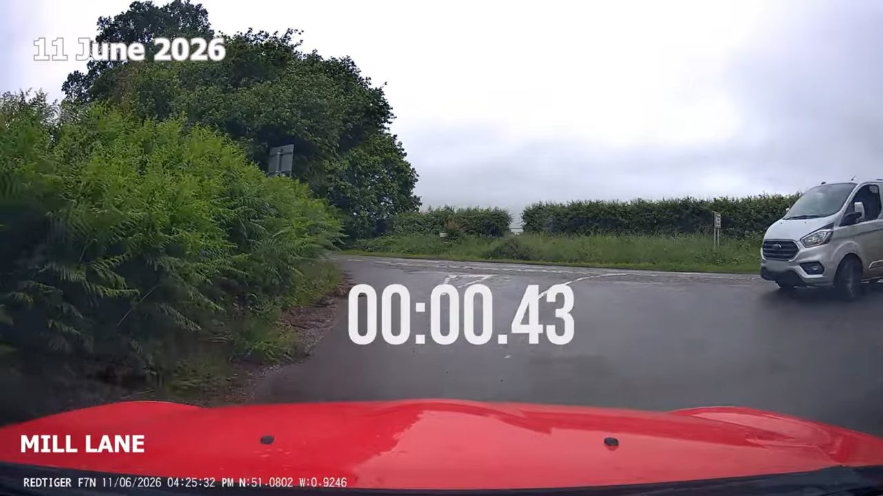 Dashcam view approaching the B3006 junction from Mill Lane on 11 June 2026; a white van crosses from the right and an on-screen timer reads 00:00.43.